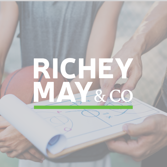 Richey May & Co title with background of a basketball coach explaining a play to his player