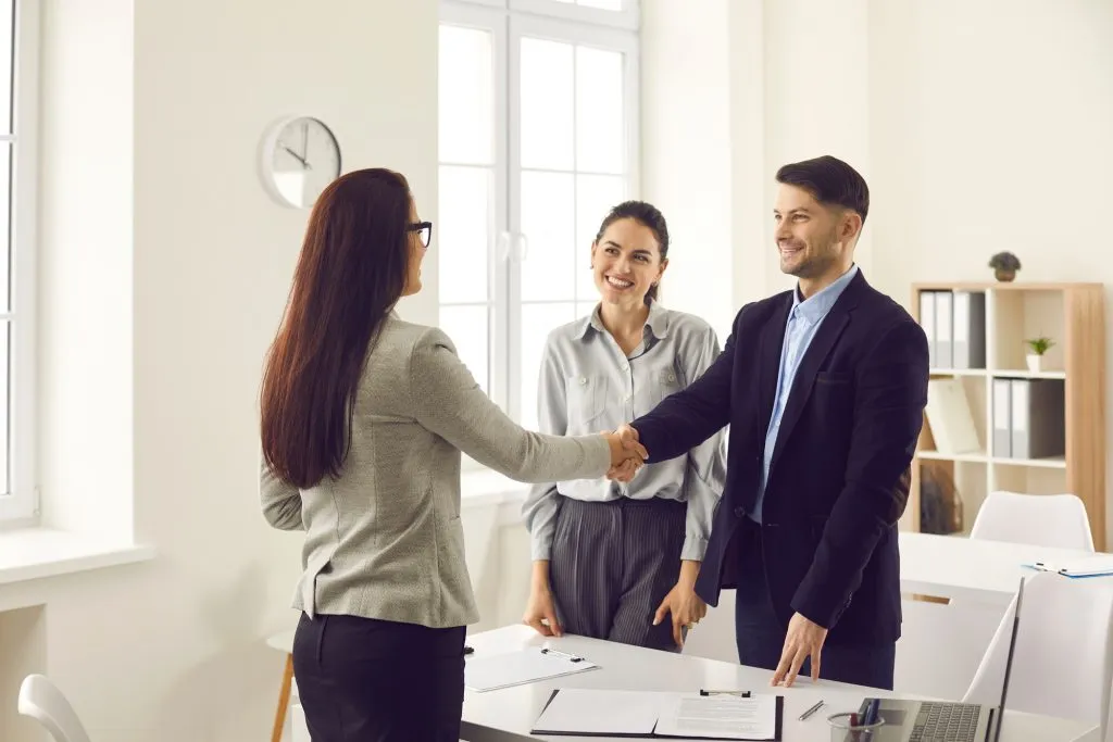 Business group greeting each other for a meeting.